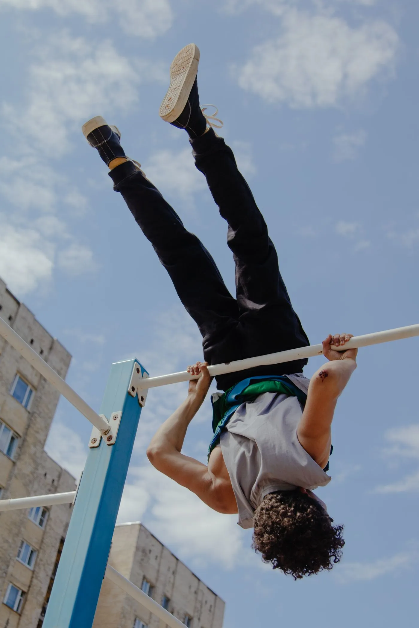 Man doing a calisthenics hold on outdoor bars