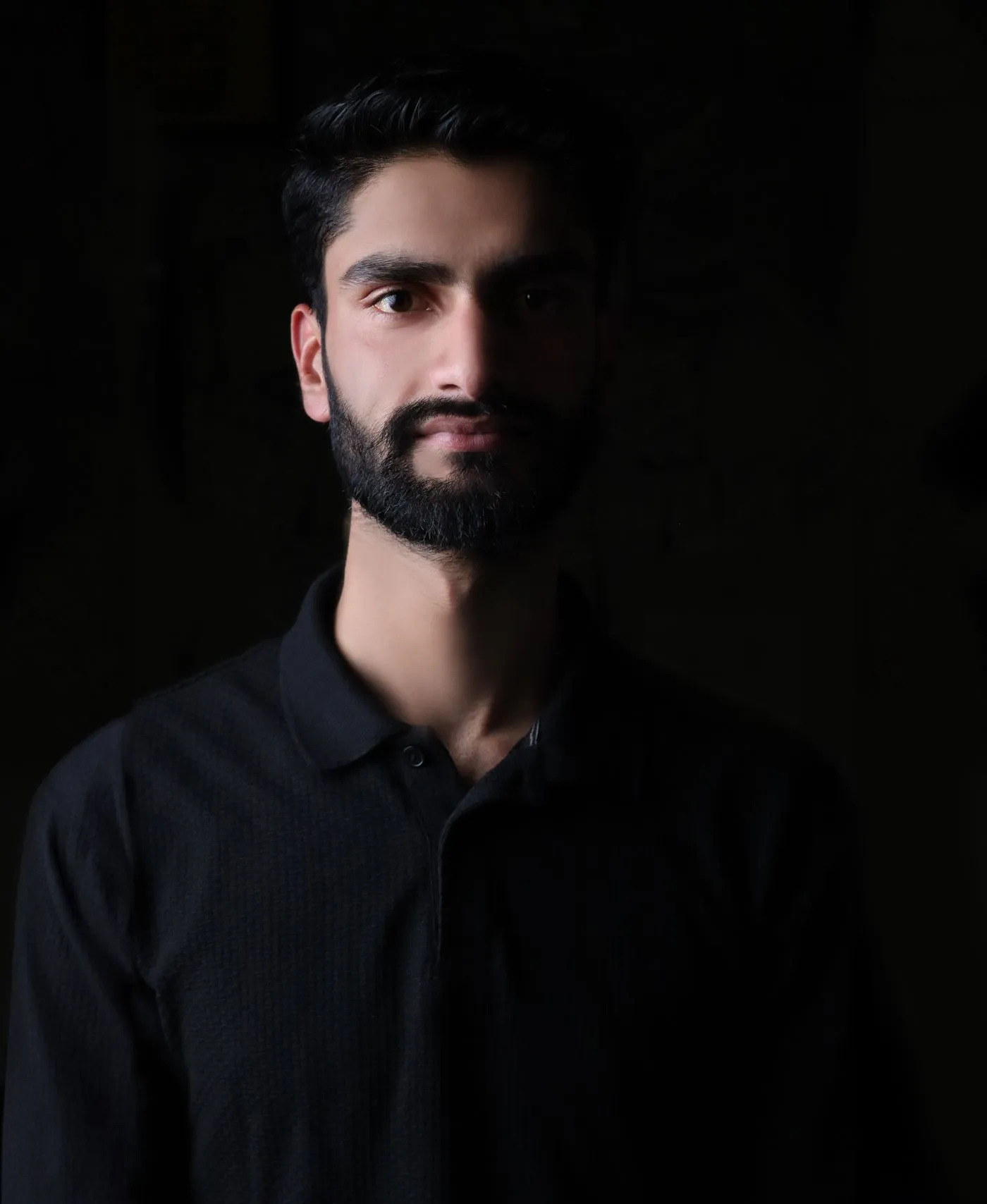 Portrait of a bearded man in low light